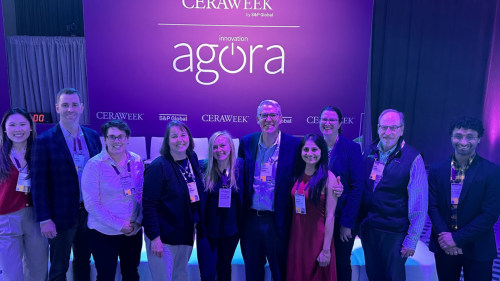 The Dartmouth delegation gathered under a sign that says CERAWeek Agora