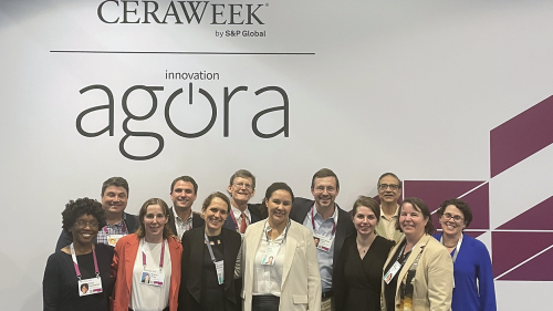 A group posing under a sign that says CERAWeek Innovation Agora