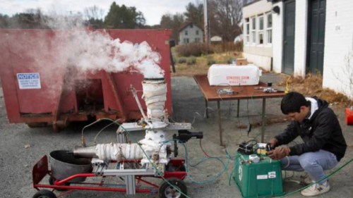 Dartmouth engineering student Ben Cavanagh '27 monitors a biomass torrefaction reactor.