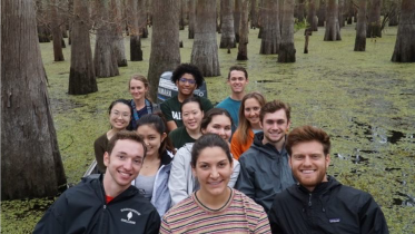 Students on the Gulf Coast trip in a boat in a swamp