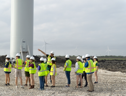 Students at the 2018 Gulf Coast immersion trip view a wind power site