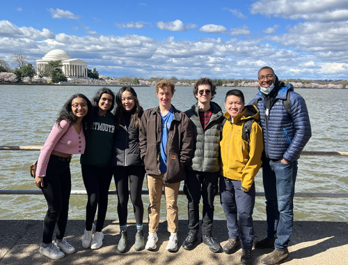 Group of students standing in front of water in DC with the Jefferson Memorial in the distance