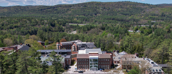 Aerial view of the Irving Institute building with trees and mountains 