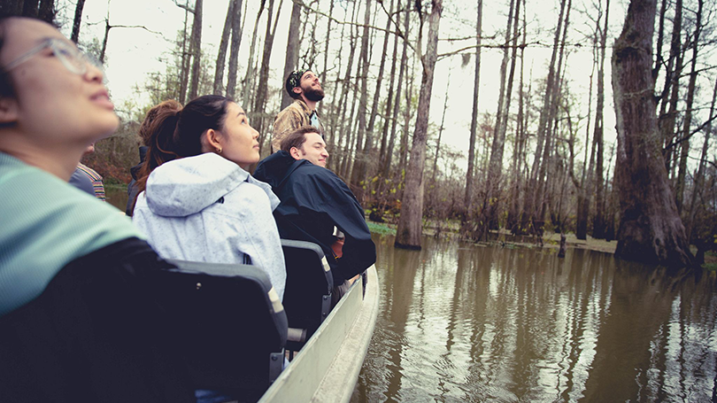 Students tour a Louisiana swamp in a boat